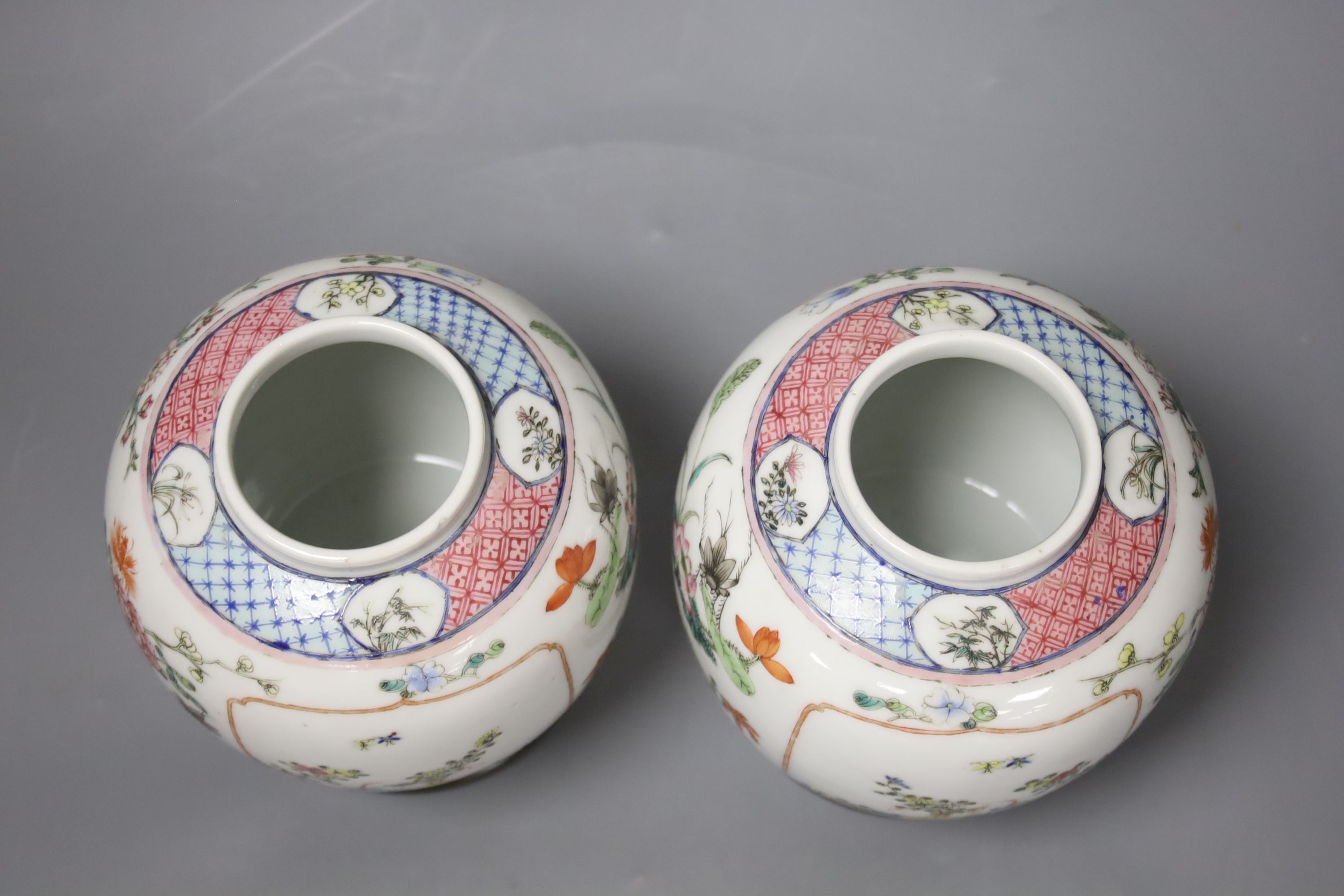 A pair of Chinese famille rose jars and covers, late 19/early 20th century, 15.5cm, on hardwood stands